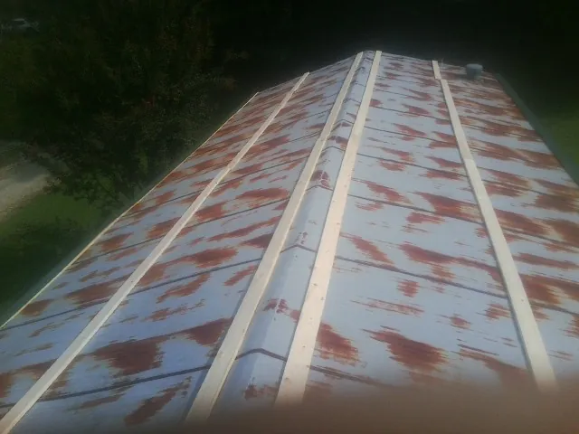 Rusted metal roof panels with new wood purlins before replacement — Storm Damage Roof Repair in Galivants Ferry by Roofing Brothers